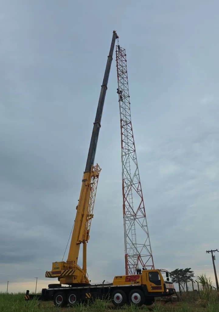 Guindaste trabalhando na montagem de torre em campo